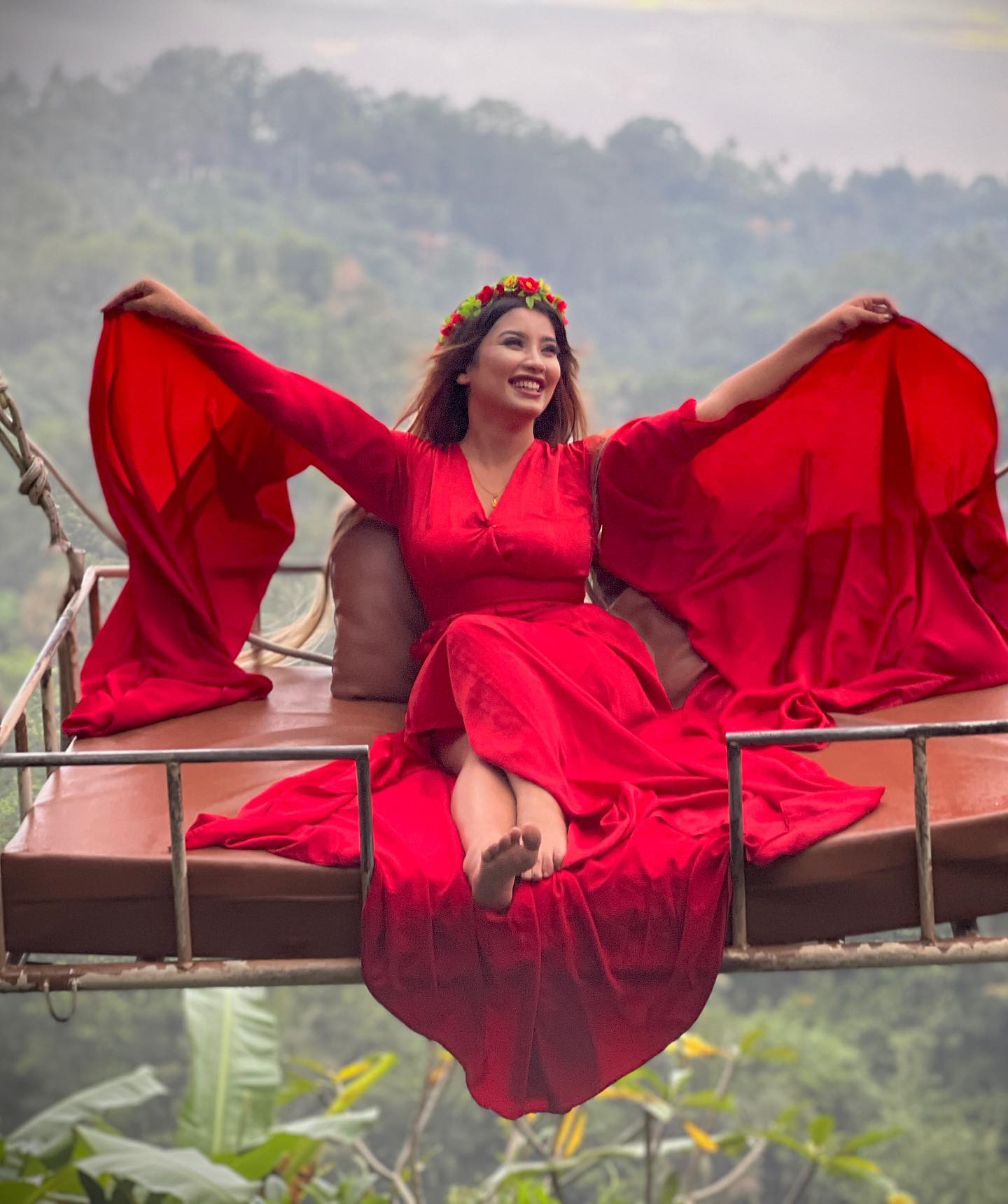 Sandhya in red outfit floating in Bali water