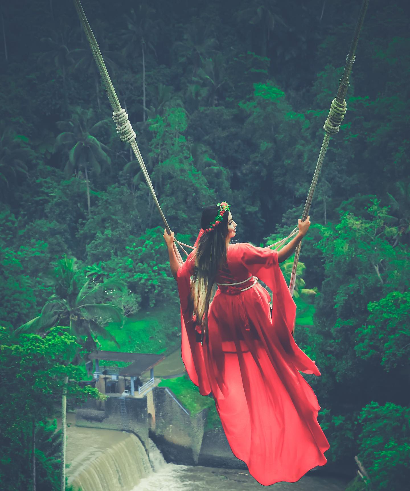 Sandhya near a waterfall in Bali, showcasing natural beauty